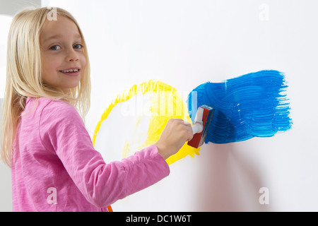 Portrait of girl painting on wall Stock Photo