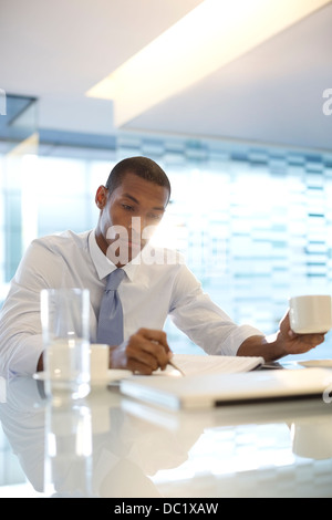 Serious businessman reading paperwork Stock Photo