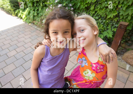 Portrait of two smiling girls hugging in stadium stand Stock Photo - Alamy