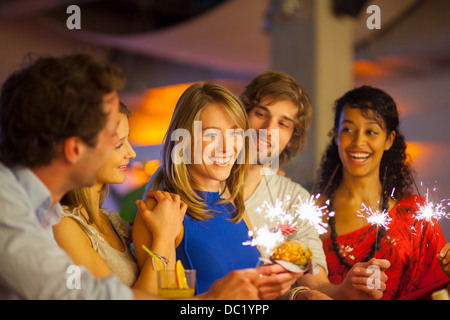Group of friends enjoying cocktails in bar Stock Photo