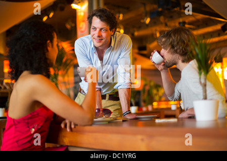 Group of friends chatting in cafe Stock Photo