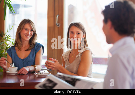 Group of friends chatting in cafe bar Stock Photo