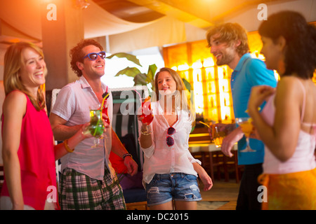Group of friends dancing in bar Stock Photo