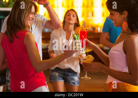 Friends drinking cocktails in bar Stock Photo