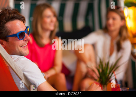 Group of friends enjoying indoor beach party Stock Photo