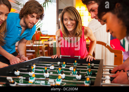 Friends playing table football Stock Photo