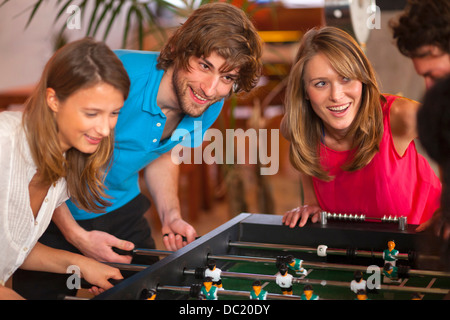 Close up of friends having fun playing table football Stock Photo