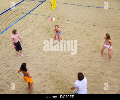 Aerial view of friends playing indoor beach volleyball Stock Photo