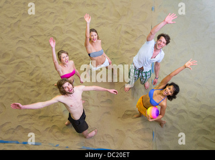 Aerial view of friends waving at indoor beach volleyball Stock Photo