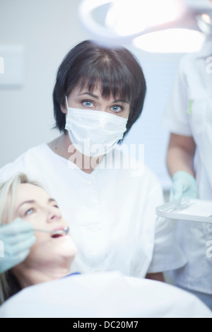 Portrait of female dentist ready to treat female patient Stock Photo