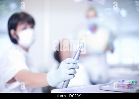 Close up of dentists hand holding ultraviolet light Stock Photo