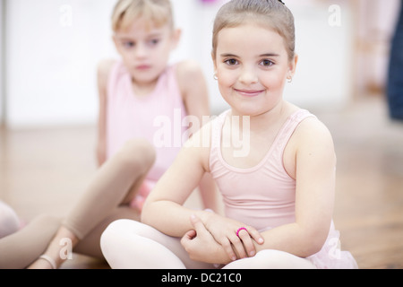 Two young ballerinas sitting on floor Stock Photo