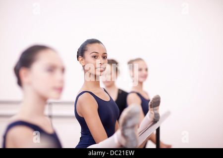 Teenage ballerinas practicing at the barre Stock Photo