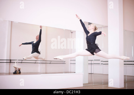 Ballerina practicing mid air jump Stock Photo