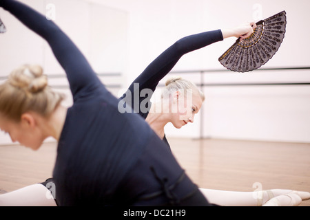 Ballerinas in symmetrical floor pose Stock Photo