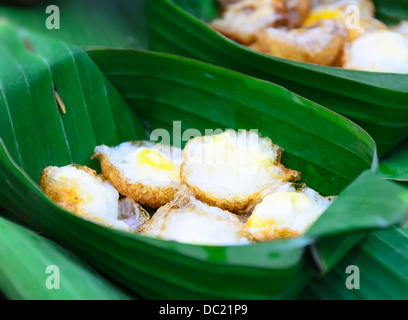Quail eggs fried in banana leaf counts Stock Photo