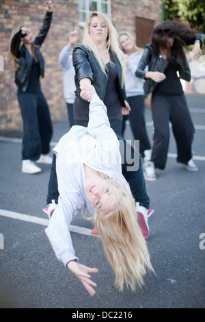 Girls dancing in carpark Stock Photo