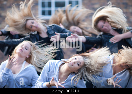 Girls practicing dance in carpark Stock Photo