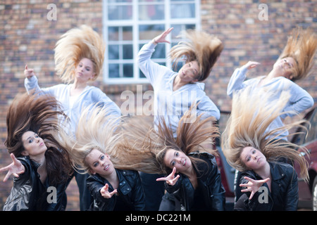 Group of girls practicing dance in carpark Stock Photo