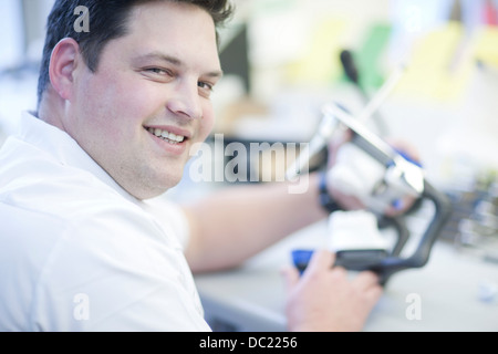 Portrait of dental technician working in lab Stock Photo