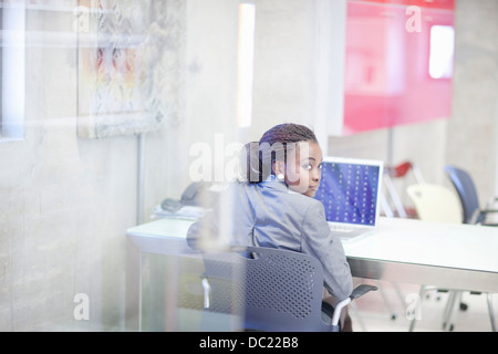 Young woman using computer in office Stock Photo