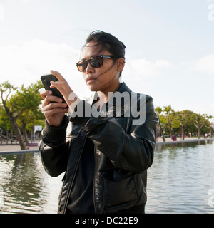 Young woman in sunglasses using mobile phone Stock Photo