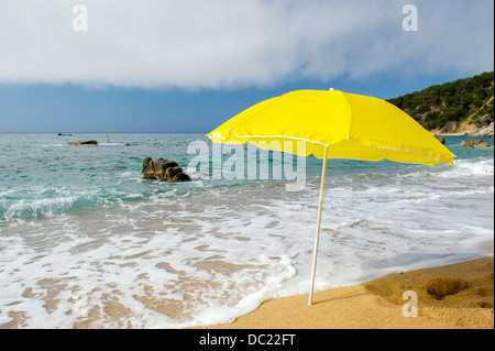 yellow parasol at the summer beach Stock Photo