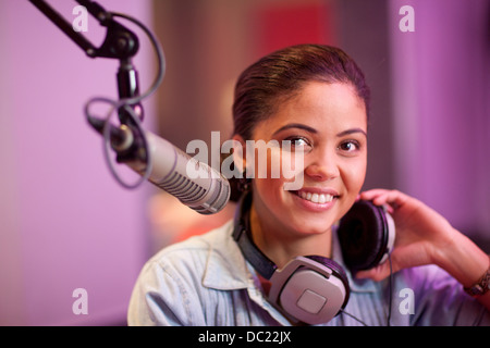 Young woman broadcasting in recording studio, portrait Stock Photo
