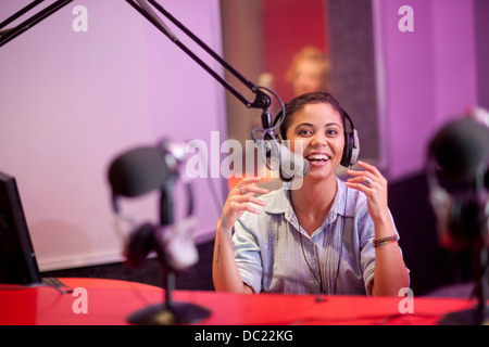 Young woman broadcasting in recording studio, portrait Stock Photo