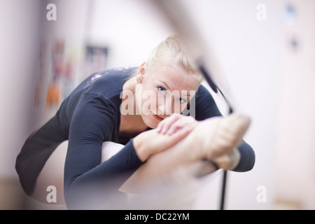 Portrait of female ballerina practicing at the barre Stock Photo