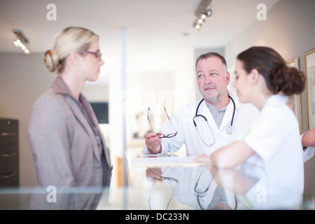 Nurse and doctor in hospital reception Stock Photo