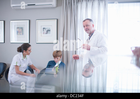 Nurse, doctor and young patient in hospital reception Stock Photo