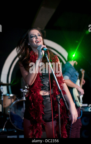 Young female singing on stage in club Stock Photo