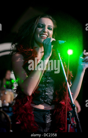 Young female singing on stage in nightclub Stock Photo