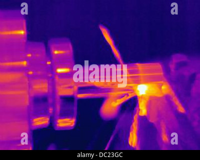 Thermal image of part being turned on lathe, with heating of the cutting tool, part and shavings Stock Photo