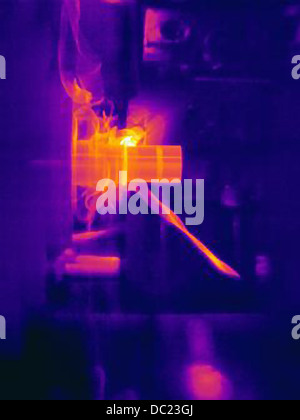 Thermal image of part being turned on lathe, with heating of the cutting tool, part and shavings Stock Photo