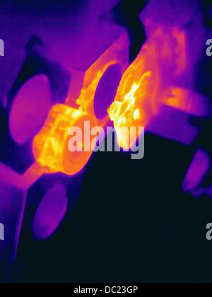 Thermal image of part being turned on lathe, with heating of the cutting tool, part and shavings Stock Photo