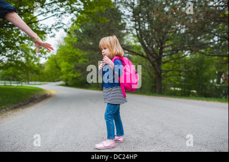Mother reaching out to hold daughter's hand Stock Photo