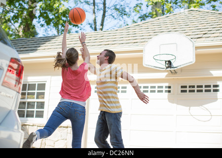 Brother and sister playing basketball Stock Photo