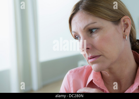 Portrait of sad mature woman looking away Stock Photo