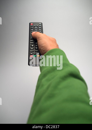 Point of view photo of hand holding remote control Stock Photo