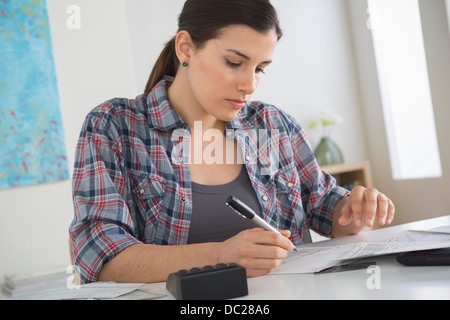 Young woman doing home finances Stock Photo