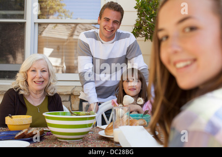 Family having breakfast outdoors Stock Photo