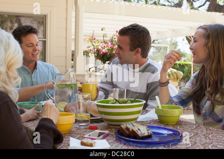 Family having breakfast outdoors Stock Photo