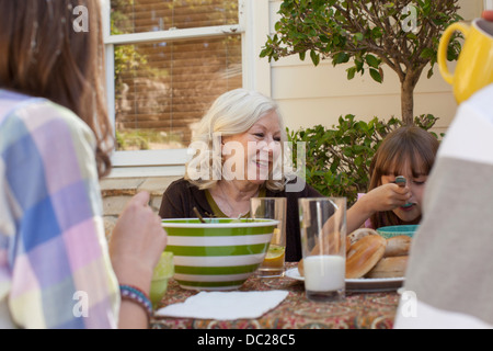 Family having breakfast outdoors Stock Photo