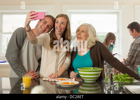 Grandchildren with grandmother photographing themselves Stock Photo