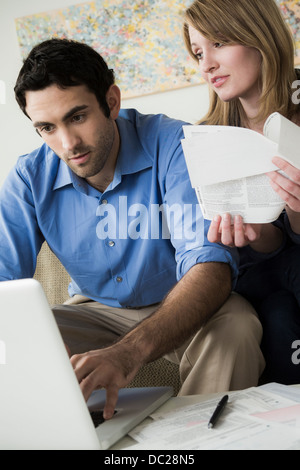 Young couple paying bills online