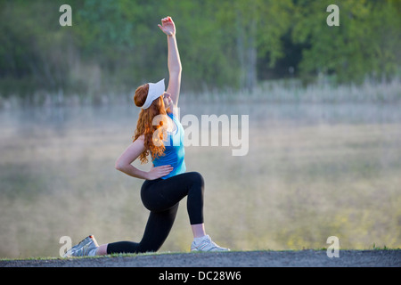 Teenage girl in sportswear stretching Stock Photo