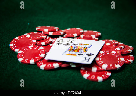 Ace and king of spades on red poker chips Stock Photo