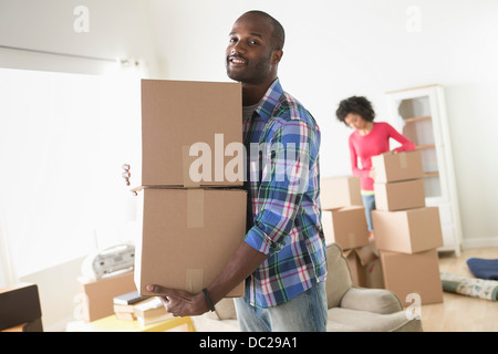 Mid adult man carrying cardboard boxes Stock Photo